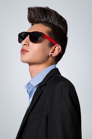 Trendy Teenager with Hair Crest in a Grey Backgroundの写真素材