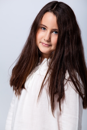 Beautiful Little Girl on a Blue Backgroundの写真素材