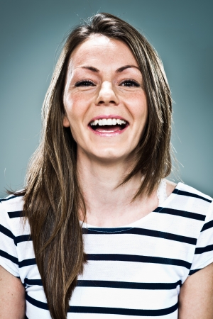 Young Woman Smiling over a Grey Backgroundの写真素材