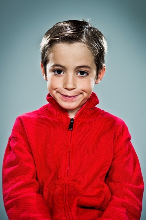 Funny Kid Smiling on a Grey Backgroundの写真素材