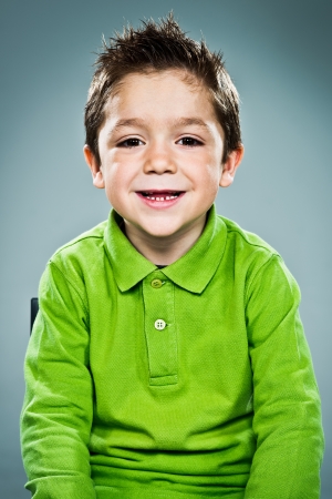 Funny Kid Smiling on a Grey Backgroundの写真素材