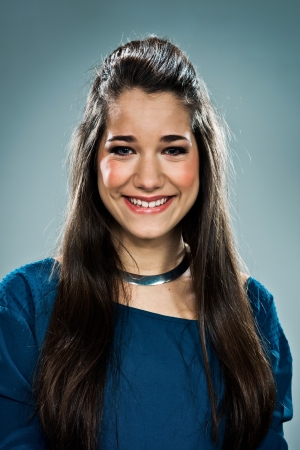 Beauty Teenager Smiling over a Grey Backgroundの写真素材