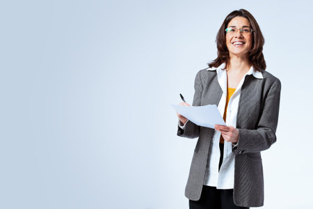 Happy Confident Business Woman over a Grey Backgroundの写真素材