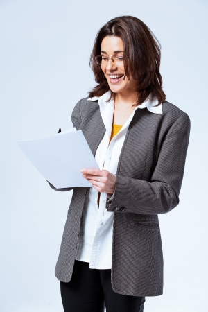 Happy Confident Business Woman over a Grey Backgroundの写真素材