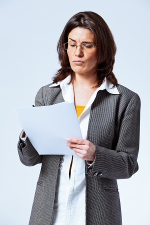 Angry Confident Business Woman over a Grey Backgroundの写真素材