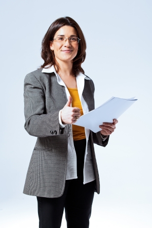 Happy Confident Business Woman over a Grey Backgroundの写真素材