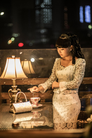 Beautiful retro Asian woman with vintage backgroundの写真素材