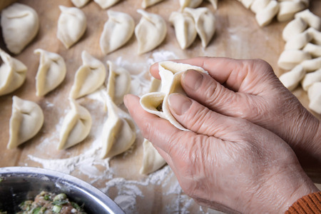 Hands making dumplingsの写真素材