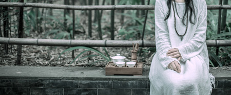 a woman sitting in the parkの写真素材