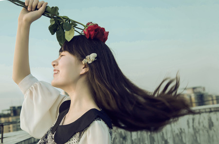 Beautiful Asian woman holding roseの写真素材