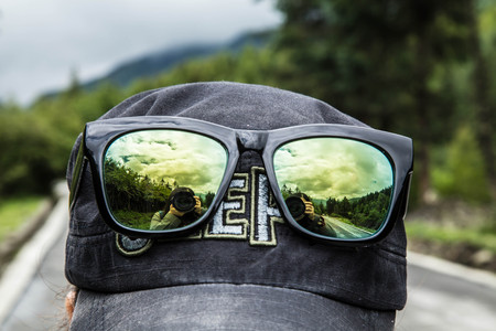 Reflection of a woman taking a photoの写真素材