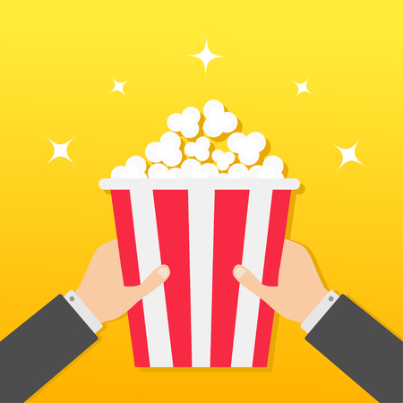 Two human businessman hands holding popcorn box. Movie Cinema icon in flat design style. Pop corn. Yellow gradient background. Shining stars. Vector illustrationのイラスト素材