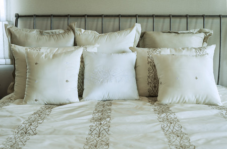 white and brown pillow on bedの写真素材