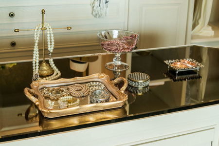 Beauty and make-up concept: mirror,jewelry and makeup set on a table