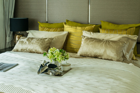 Decorative set with book,tea set and glasses on the bedの写真素材