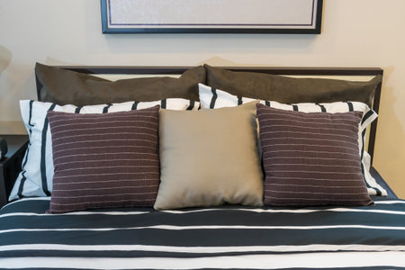 modern bedroom with brown, black and white pillows