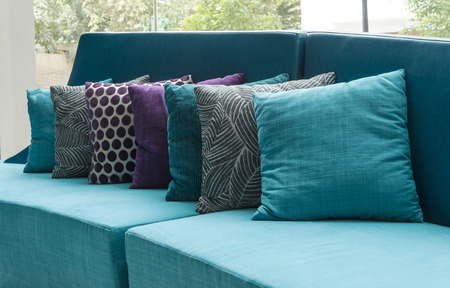 living room with row of pillows on sofa at homeの写真素材