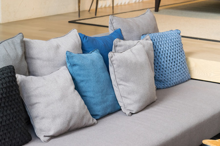 row of pillows on sofa in living roomの写真素材
