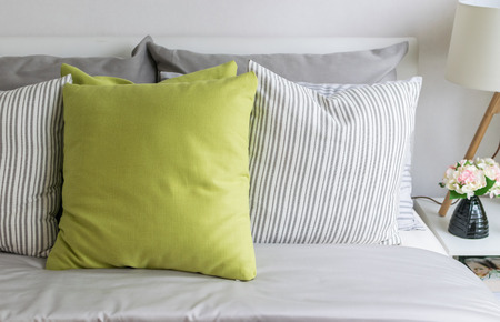modern bedroom with green pillow on bedの写真素材