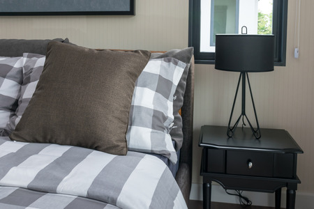 bed and brown pillows in modern bedroomの写真素材