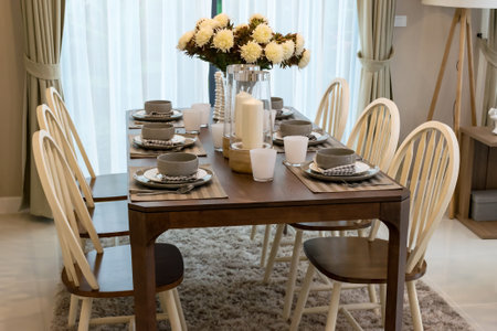 dining table and comfortable chairs in modern home with elegant table setting