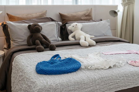 modern kids room with dolls and pillows on bedの写真素材