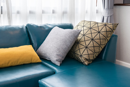 modern living room with green sofa and pillows at homeの写真素材