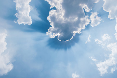 clouds in blue sky with sunrays