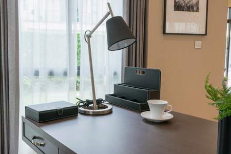 wooden table and books in modern working room interiorの写真素材