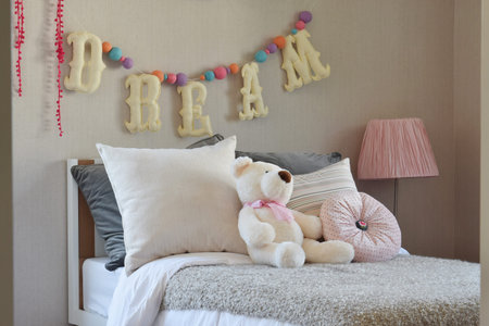 modern kids room with doll and pillows on bedの写真素材