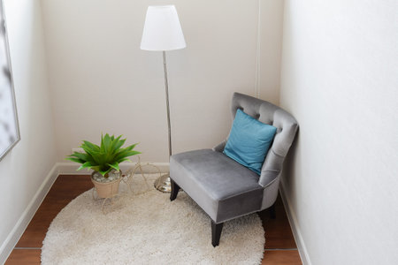 luxury grey tweed sofa with blue pillow in living corner at homeの写真素材