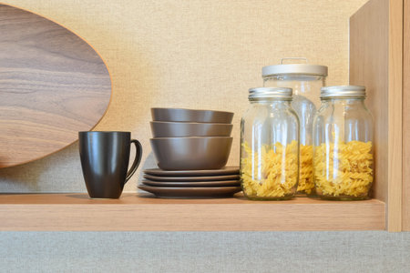 modern ceramic kitchenware and utensils on pantry shelf