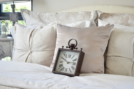 luxury bedroom interior with classic style alarm clock on bedの写真素材