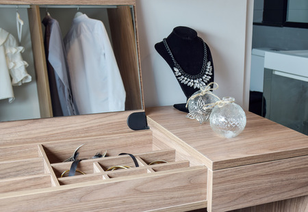 Crystal jars and necklace on wooden dressing tableの写真素材
