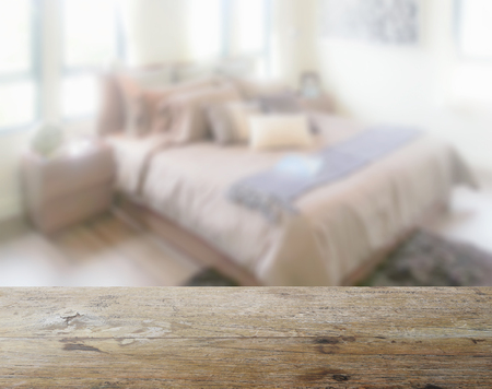 wooden table top with blur of modern living room interior as backgroundの写真素材