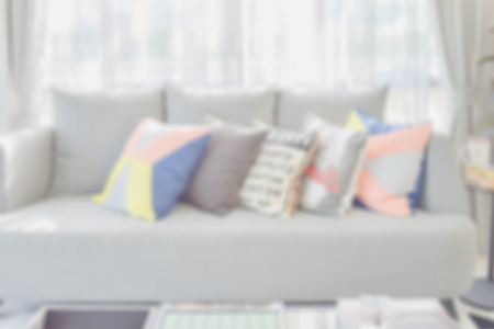 blur image of modern living room design with colorful pillows on sofa for backgroundの写真素材