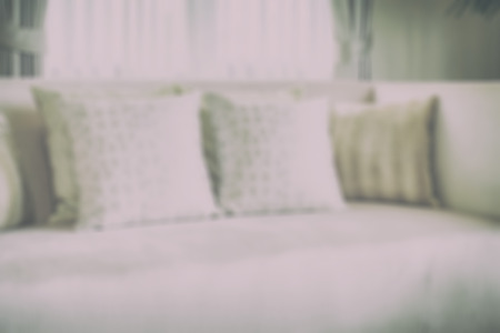 blur image of luxurious style pillows on satin upholstery sofaの写真素材