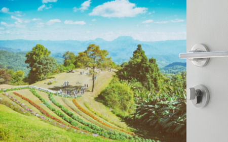 opened white door to beautiful landscape with mountain and flower from viewpoint of huay nam dung national park , Chiangmai , Thailandの写真素材