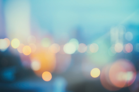 abstract background with bokeh defocused lights and shadow from cityscape at night, vintage or retro color toneの写真素材