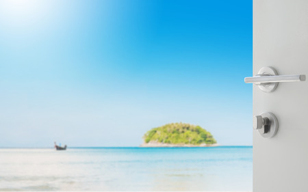 opened white door to beautiful seascape with blue sea beach island and the long tail boat under clear sky in summer,kata beach - phuketの写真素材