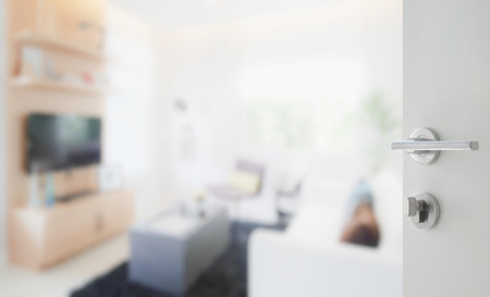 opened white door to modern living room interiorの写真素材