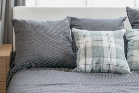 grey and checked green pillows in modern bedroom interiorの写真素材