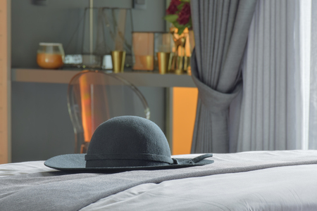 Black hat setting on bed with modern classic style interior bedroomの写真素材