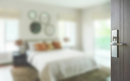 opened wooden door to modern bedroom interiorの写真素材