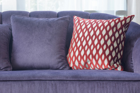 Close up red crossed pattern pillow with violet sofa setの写真素材