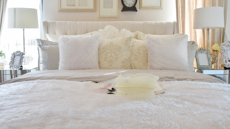 vintage style bedroom interior with white pillows and decorative table lampの写真素材