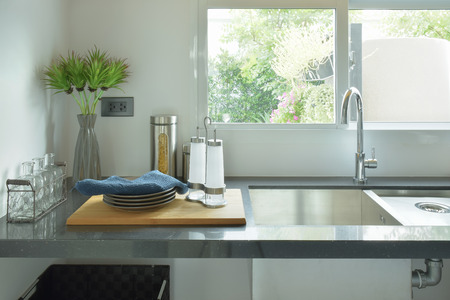 Dishes next to sink in the kitchenの写真素材