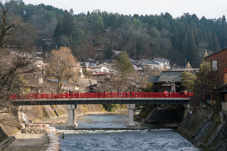 Takayama, Japan - Fubruary 21, 2016: Red Nakabashi Bridge across Miyagawa river with tourist in winterのeditorial素材
