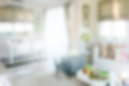 Blurred dining table next to sofa set in modern interior multi purpose areaの写真素材
