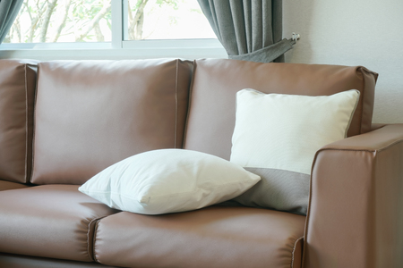 Close up pillows on brown leather sofaの写真素材